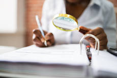 40944316-auditor-investigating-fraud-using-magnifying-glass.jpg